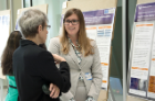 Resident Amanda Ribbeck, MD (right) discusses her research with Susan Graham, MD.