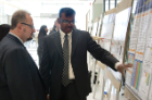 Endocrinology fellow Kadapalakere Reddy, MD (right), shares his research results with Peter Elkin, MD.