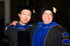 Wei Luo celebrates his doctoral degree with his mentor Lee Ann Garrett-Sinha, PhD, associate professor of biochemistry.