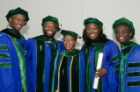 From left, Michael Williams, Okari Owate, Janelle Duah, Chinelo Ogbudinkpa and Prince Bonsu gather to celebrate and congratulate each other following the commencement exercises.