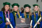 From left, Lauren Jepson, Michele Smith, Chelsey Ciambella and Sarah Riley take a moment to commemorate their official distinction as doctors following the commencement exercises.