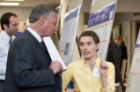 Kaci Schiavone shares her research on shoulder arthoplasty with Michael E. Cain, MD, dean of the Jacobs School of Medicine and Biomedical Sciences.