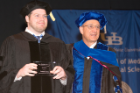 Doctoral graduate Thomas Covey was awarded the Bishop Neurosicence Thesis Award by Malcolm M. Slaughter, professor of physiology and biophysics.