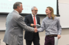 Robert Bruce shakes hands with Michael E. Cain, MD, left, after receiving his Dean’s Letter of Commendation from Alan J. Lesse, MD, center.