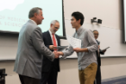 Rongjia Deng accepts congratulations from Michael E. Cain, MD, after receiving his Dean’s Letter of Commendation.