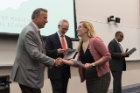 Sara Diletti is congratulated by Michael E. Cain, MD, left, after getting her Dean’s Letter of Commendation. David A. Milling, MD, right, announced the honorees and Alan J. Lesse, MD, second from left, handed out the honors.