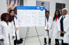 Students from the Research Laboratory High School for Bioinformatics & Life Sciences in Buffalo with their research poster.