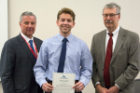 Austin Bartl received an award for the highest continued average in the anatomical sciences. Presenting the honor were Michael E. Cain, MD, left, and Richard T. Cheney, MD.