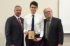 Nico Shary was given the Ernest Witebsky Award for achieving the highest grades in microbiology and immunology. Presenting were Michael E. Cain, MD, left, and Terry D. Connell, PhD. 