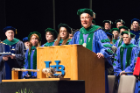 Michael E. Cain, MD, vice president for health sciences and dean of the medical school, speaks during the 173rd annual Jacobs School of Medicine and Biomedical Sciences commencement May 3 at the Center for the Arts.