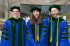 New doctors, from left, Alexander Clark, Sarah Sonenberg and Andrew Knapp smile outside the Center for the Arts following commencement. 