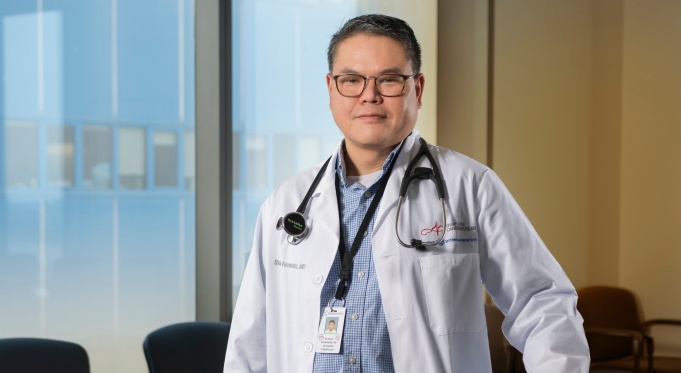 Stanley F. Fernandez, MD, PhD, stands in a clinic’s waiting room. 