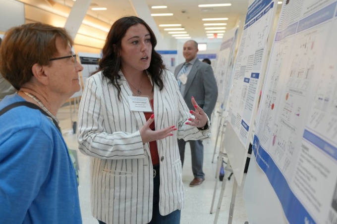 Alexsandra Lenhard discussing her poster.