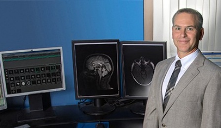 David Hojnacki, MD, and computer displays of neurological images. 