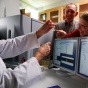 Ray Kelleher, left, and Wade Sigurdson, middle, examine a sample with a student in the Flow Cytometry and Cell Sorting facility. 