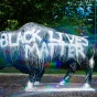 Bull Statue painted with Black Lives Matter white paint. 