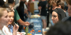 Students discussing involvement opportunities at the club fair.