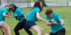 Students playing tug of war during their neighborhood field day.