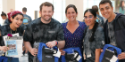 Students holding their Alumni Association lunch bags gifted to them by Jessica Donhauser, MD, president of the Alumni Association (middle).