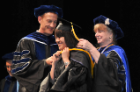 A student from the Department of Biotechnical and Clinical Laboratory Sciences, Jing Ying Eng, is hooded by her mentor, Kate Rittenhouse-Olson, PhD.