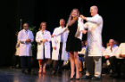 Christina Douglas beams with pleasure as she receives her white coat.