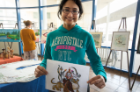 Biochemistry student Anushila Chatterjee displays an example of quilling she created by rolling and shaping strips of colored paper.