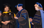 Srinidhi Sridhar, a graduate in the master’s program, is hooded by Paul J. Kostyniak, PhD, as Patricia A. Masso-Welch, PhD, looks on.