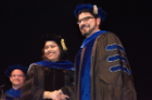 Dithi Banerjee, a doctoral graduate, is congratulated by John C. Panepinto, PhD, associate professor of microbiology and immunology.