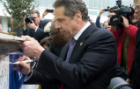 New York State Gov. Andrew M. Cuomo inscribes the beam. The $375 million new medical school is funded in part by NYSUNY 2020 legislation that he signed into law.