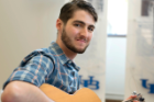 Music is art, and first-year medical student Matthew Kaye played the acoustic guitar to supply audio entertainment at the arts festival. 