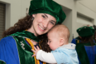 Emily A. Ulrich shares a joyful moment with her child. Ulrich, who graduated in the top 10 percent of the class, will undertake UB’s pediatrics residency.