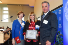 Roseanne C. Berger, MD (left), and Michael E. Cain, MD (right), present an award to Amanda Przespolewski, DO, who was honored for her project on immune responses and inhibition of marrow vasculature in acute myeloid leukemia.