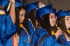 Bachelor of science graduates Andrulisa Z. Jones, left, and Jiwon Jung join classmates in moving their tassels to their left side, a sign of graduation.