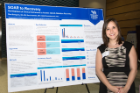 Family medicine resident Diva Bomgaars, MD, poses next to her poster during the Department of Medicine’s sixth annual Research Day.