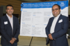 Cardiovascular disease fellow Abhishek Sawant, MD, left, and Umesh Sharma, MD, PhD, assistant professor of cardiovascular medicine, are photographed with their research poster.