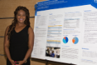 Kenyani S. Davis, MD, assistant professor of general internal medicine, is pictured with her research poster presentation.