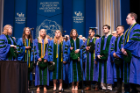 Members of the medical student acapella group, Docapella, perform the National Anthem at the opening of the medical school’s commencement ceremony.