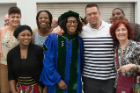 Shanté White poses with family and friends following the Jacobs School’s commencement. She earned her medical degree after graduating from UB’s School of Nursing in 2012.