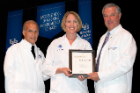 Dori R. Marshall, MD ’97, center, received the Leonard Tow Humanism in Medicine Award. Charles M. Severin, MD, PhD, left, and Michael E. Cain, MD, congratulate her.