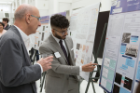 Sibtain Mustafa, a BS/MS dual degree student in pharmacology and toxicology, explains his research to Malcolm M. Slaughter, PhD, professor of physiology and biophysics.