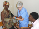 Margaret H. McAloon, MD, cares for one of the many Haitian patients with high blood pressure.