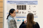 Guolei Zhao discusses her poster with a conference attendee.