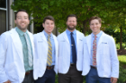 From left, Jonathan Goc, Jack Looney, Daniel Barton and Bradley Hawayek have transitioned to their clinical training years at the Jacobs School.