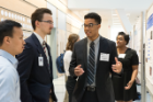 Jalen Bonitto, a student in the Institute for Strategic Enhancement of Educational Diversity Summer Research Experience program, explains his research to a pair of colleagues.
