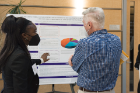 Medical student Olumayowa Adebiyi explains her research on the multifactorial complexities of autoimmune development in the skin disorder pemphigus vulgaris to Stanley W. Halvorsen, PhD.