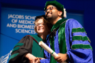Rishi Gupta poses for a photograph with Dean Allison Brashear, MD, after receiving his diploma.