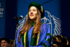 Jenna Evalyn Betz sings the “UB Alma Mater” during the commencement ceremony.