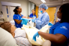 Nursing students and a resident conduct a successful simulation of delivering a baby together.