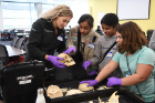 First-year medical student Julia Liberto (at left, holding skull) examines human bones with (from left) Chand Kodial, Norah Altamimi and Izabelle Tucholski.