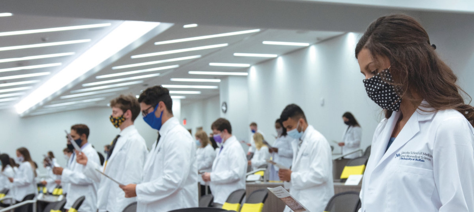 Medical students in a socially-distanced classroom wearing masks. 
